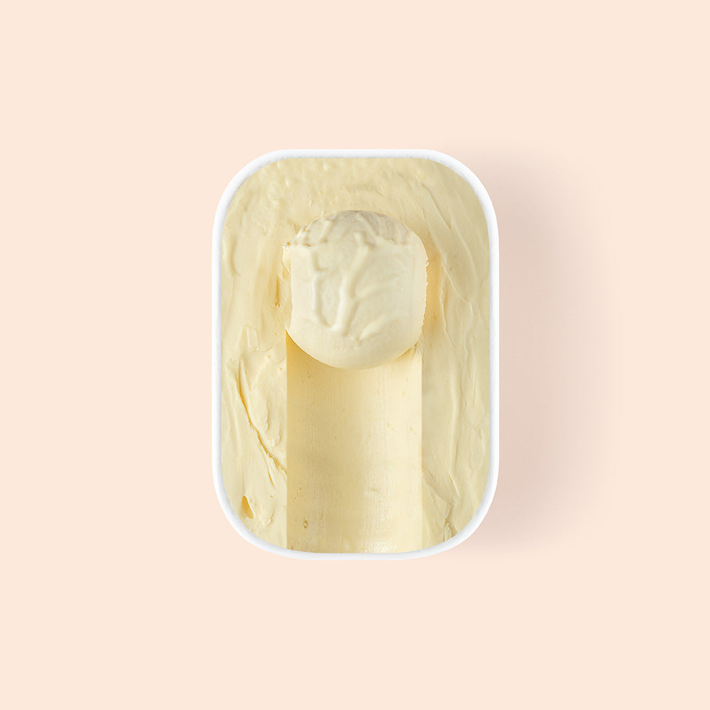 Overview of half scooped coconut mango gelato